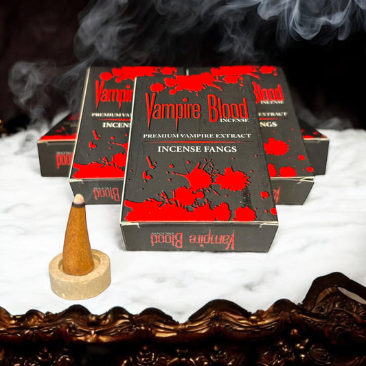 Neatos Elements Vampire Blood Incense Cones, a single cone burning with smoke, in gothic packaging with red blood splatters.
