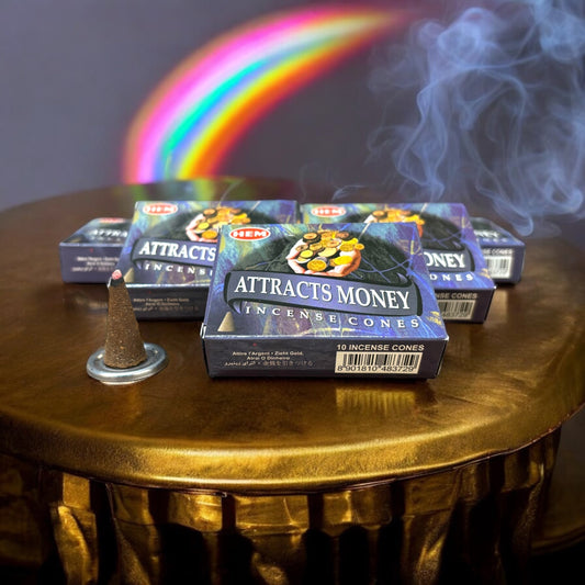 Neatos Elements Attracts Money incense cones with an invigorating herbal scent, designed to draw prosperity. One cone burns on a metal stand.