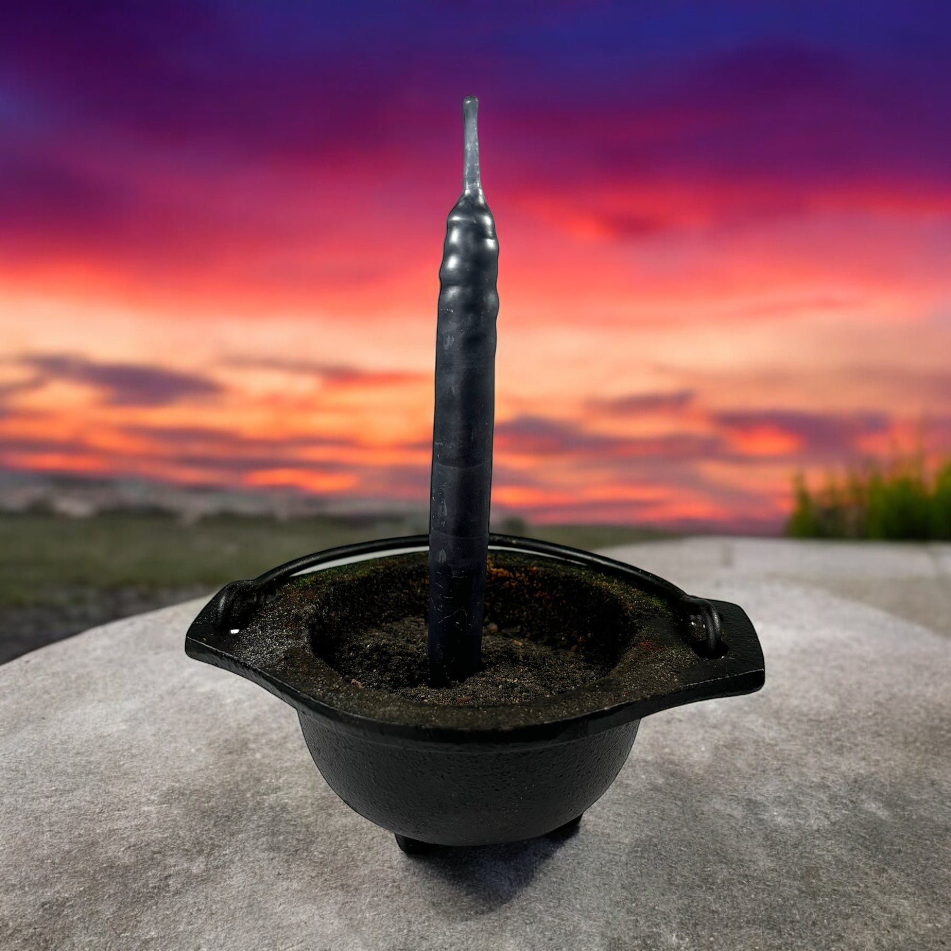 Neatos Elements hand-dipped black candle in a cauldron, ideal for protection, scrying, divination, and magic.