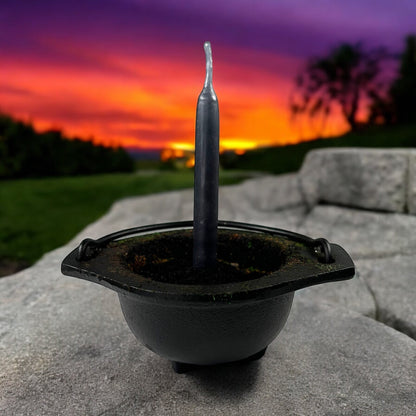 Neatos Elements hand-dipped black chime candle in a cauldron, ideal for protection and divination rituals.
