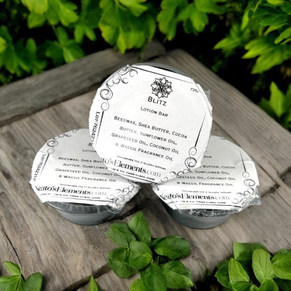 Neatos Elements Blitz Lotion Bar, a solid moisturizing bar with beeswax, shea butter, and cocoa butter, on a wooden surface with greenery.