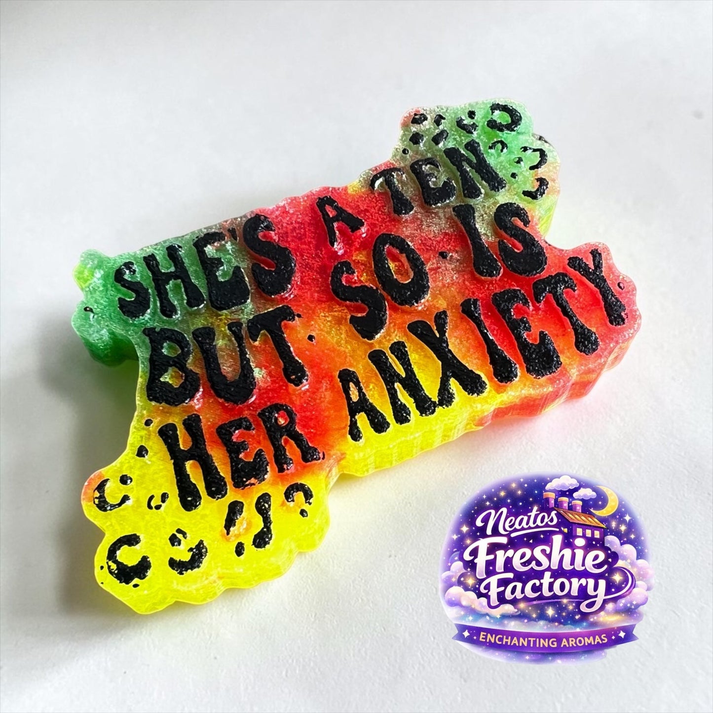 Neatos Elements Paradise Gone Wild car freshie with text "She's a ten but so is her anxiety". Gradient colors of green, yellow, orange, and red.