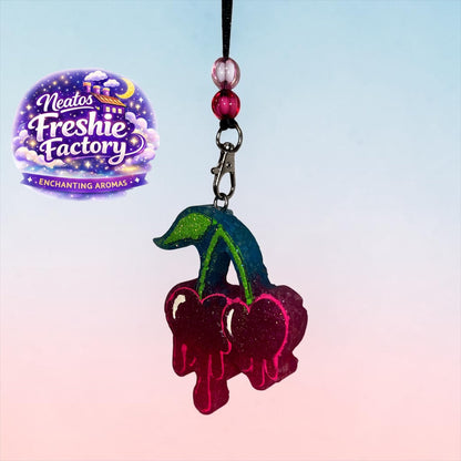 Neatos Elements handmade cherry-shaped car freshie hanger with pink and blue glitter, two beads, and swivel clip.