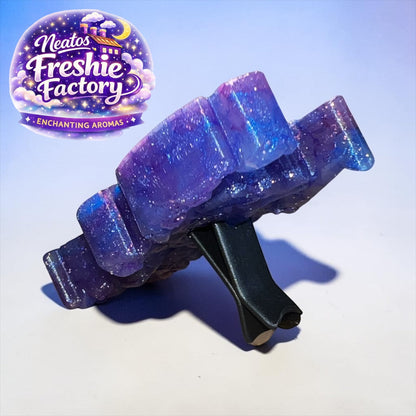 Neatos Elements Heartbreaker Cosmic Critter Freshie, a purple and blue glittery aroma bead car vent clip.