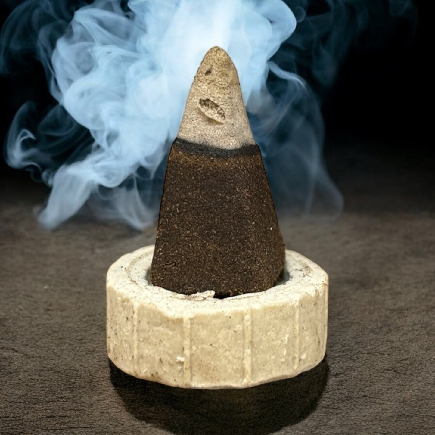 Neatos Elements Go Away Evil Incense Cone burning with white smoke, dark brown and tan colors