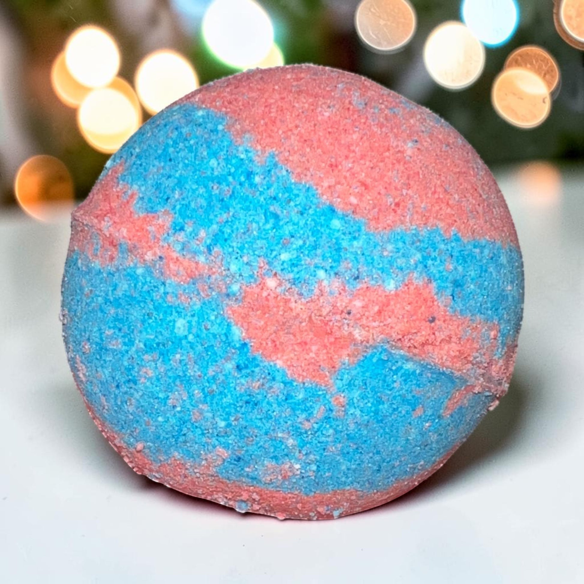 Neatos Elements Heartbreaker bath bomb, swirled blue and pink, with hidden crystal.