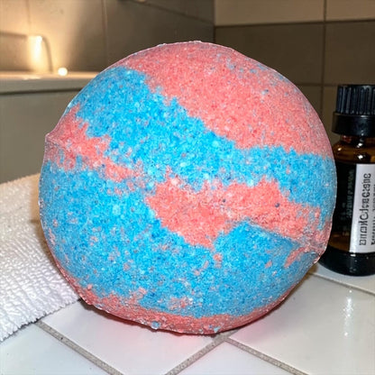 Neatos Elements Heartbreaker bath bomb, swirled blue and pink, with hidden crystal.