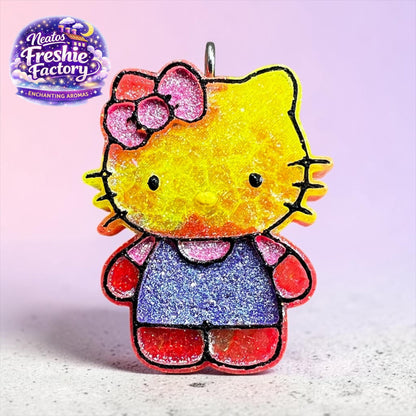 Neatos Elements Island Sunset Hello Kitty car freshie with glittery yellow face, pink bow, blue dress, and red accents.