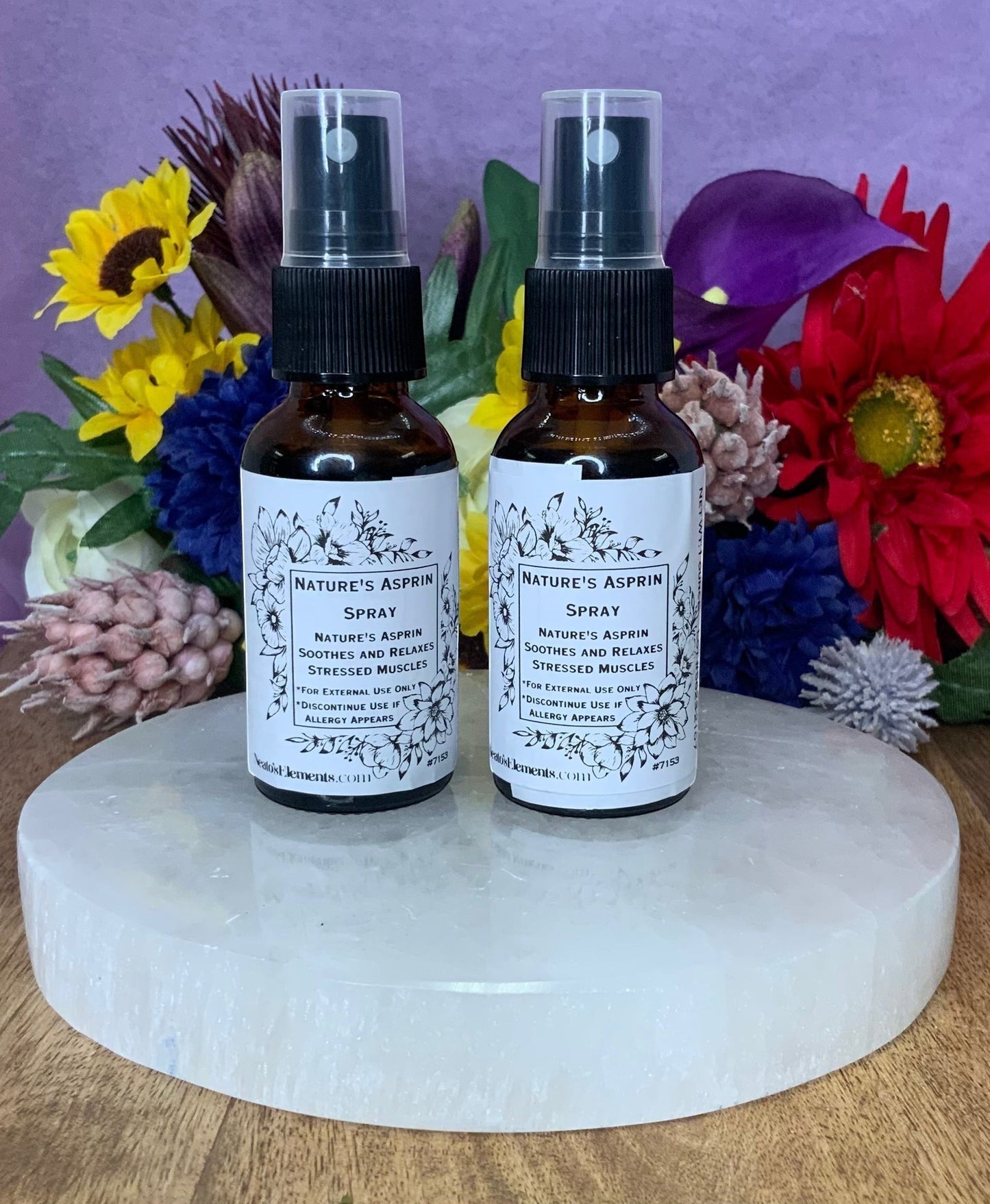 Neatos Elements Nature's Asprin herbal spray in amber glass bottles with black spray tops, soothing stressed muscles.