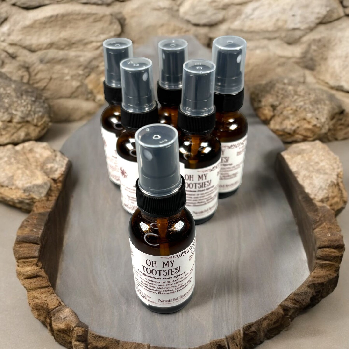Neatos Elements Oh My Tootsies! Magnesium Foot Spray in amber glass bottle with spray top. Scented with lavender & chamomile.