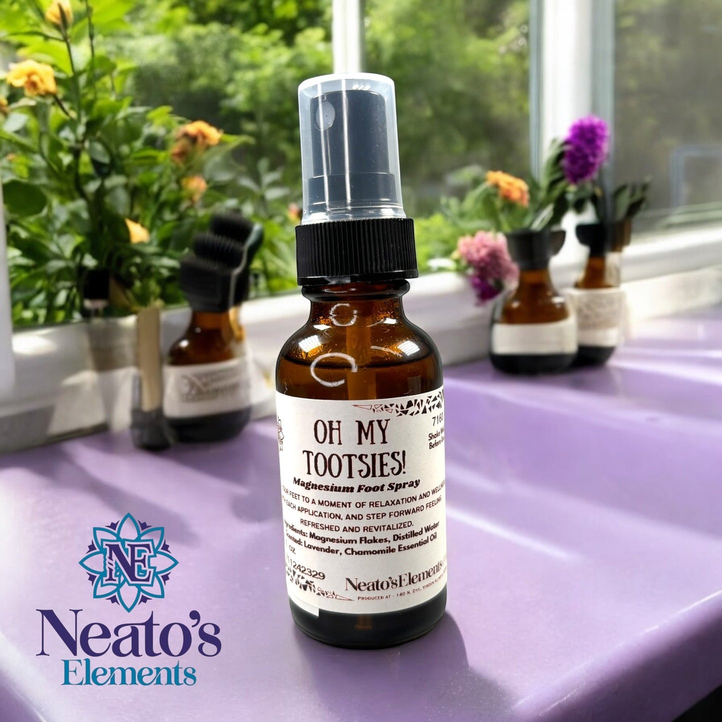 Neatos Elements Oh My Tootsies! Magnesium Foot Spray in a 1 oz amber glass bottle with a black spray top. Scented with lavender and chamomile.