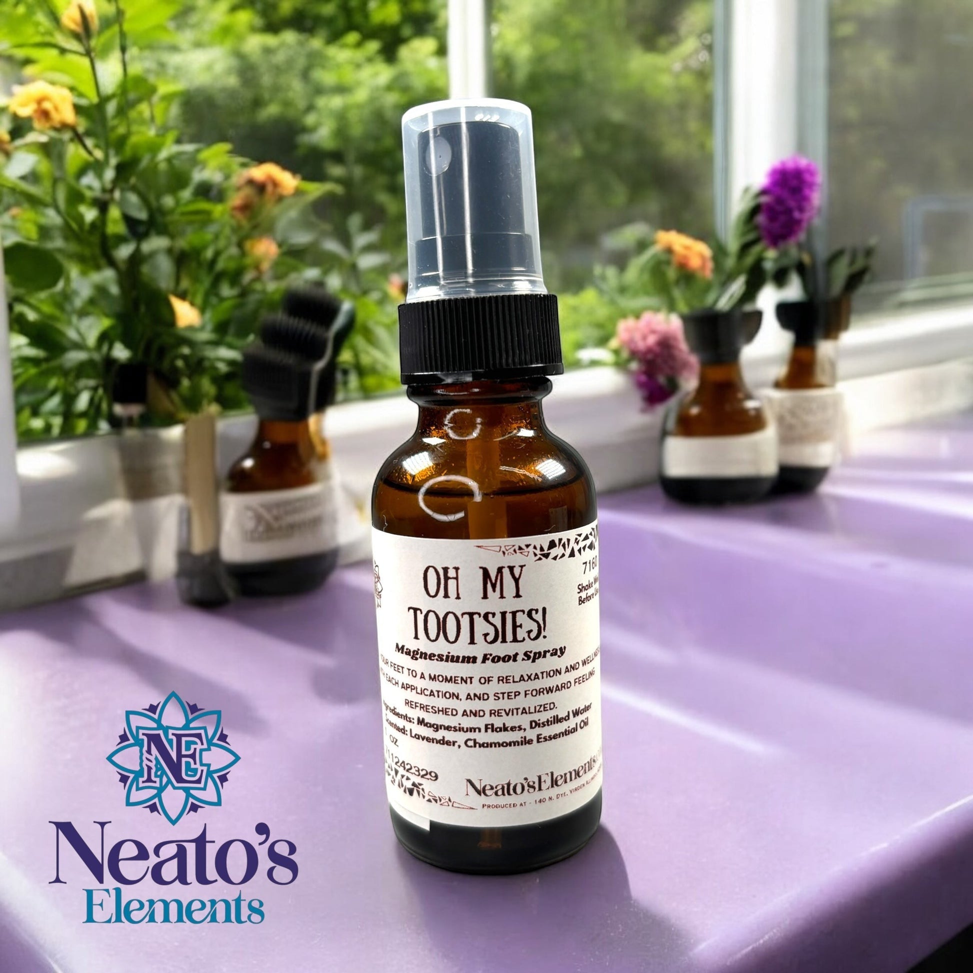 Neatos Elements Oh My Tootsies! Magnesium Foot Spray in a 1 oz amber glass bottle with a black spray top. Scented with lavender and chamomile.