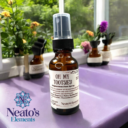 Neatos Elements Oh My Tootsies! Magnesium Foot Spray in a 1 oz amber glass bottle with a black spray top. Scented with lavender and chamomile.