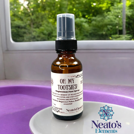 Neatos Elements Oh My Tootsies! Magnesium Foot Spray in a 2 oz amber glass bottle with a black spray top. Unscented.