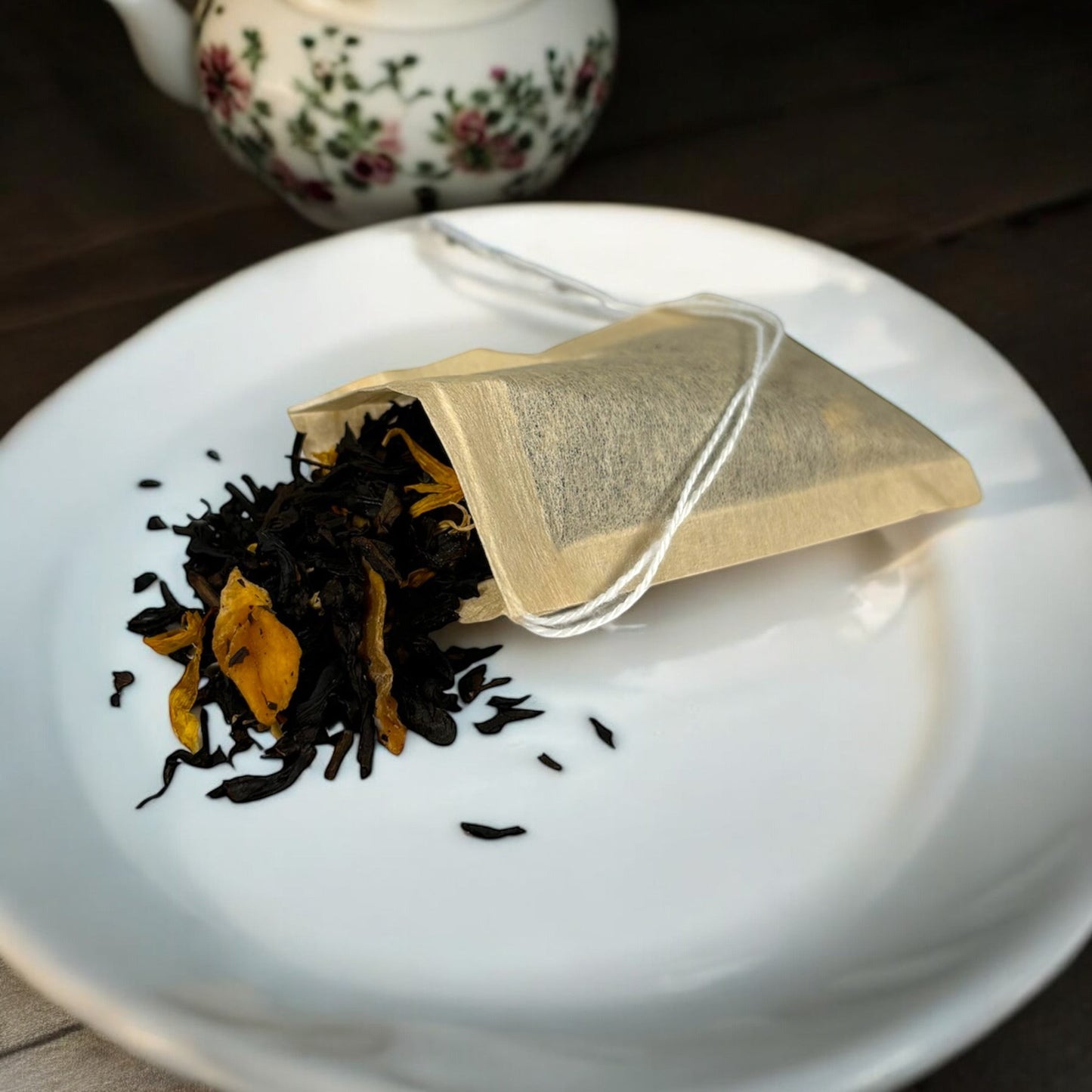 Neatos Elements Mango Royale black tea blend with dried mango pieces and marigold petals in a tea bag.