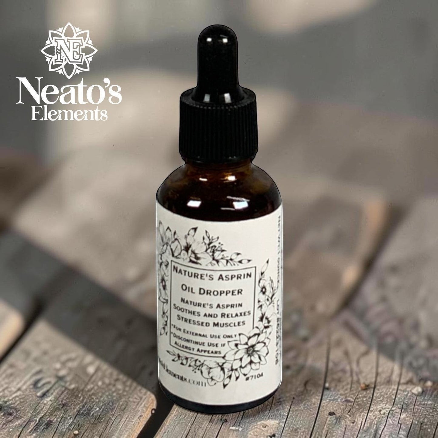 Neatos Elements Nature's Asprin herbal oil dropper bottle with black dropper top and white label with floral design.