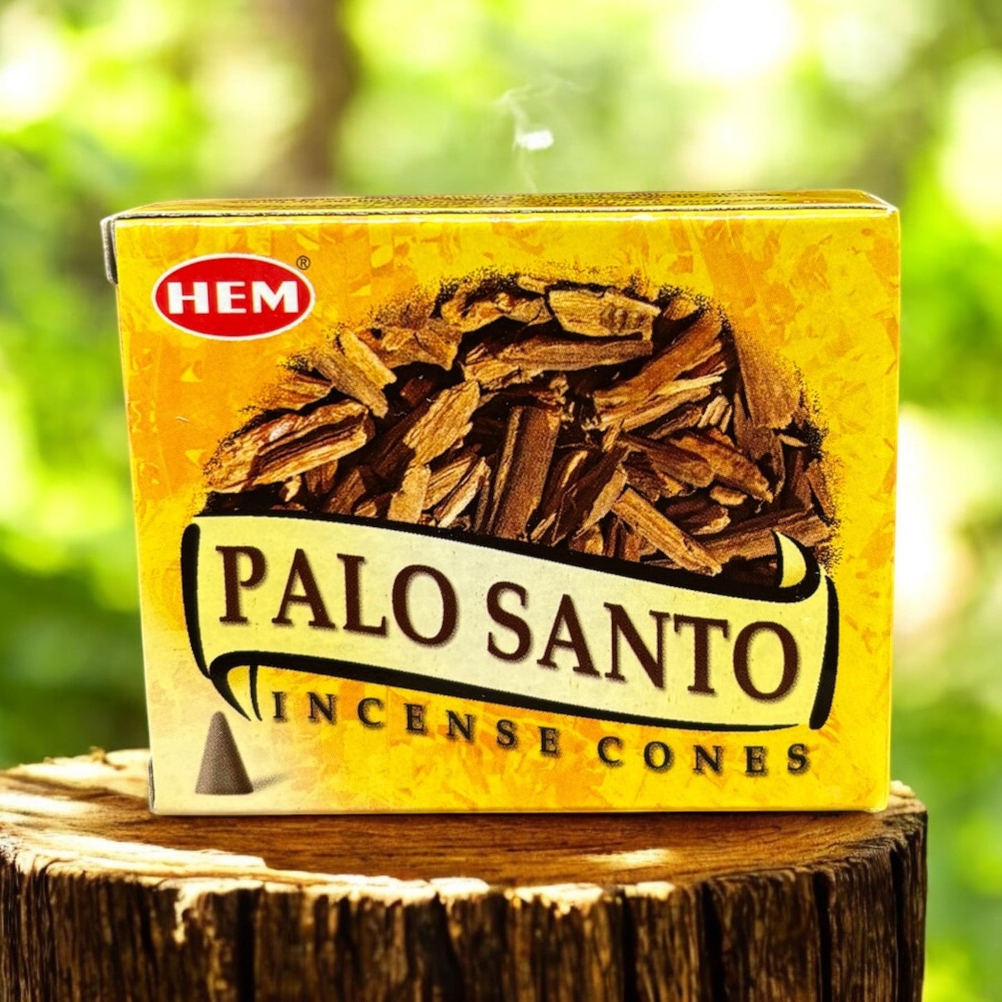 Neatos Elements Palo Santo Incense Cones box with a pile of wood chips on a rustic wooden stump.
