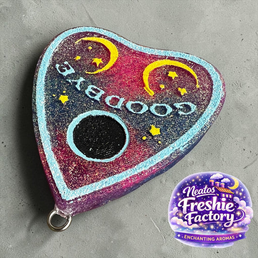 Neatos Elements heart-shaped planchette car freshie with "Goodbye" text, moons, and stars. Pink, purple, blue, and yellow.