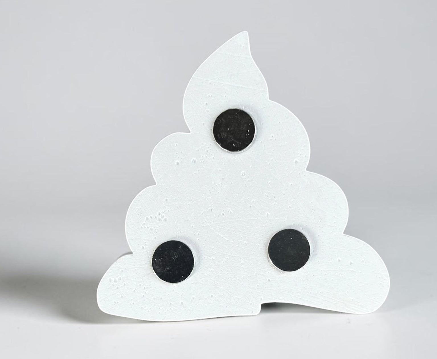 Neatos Elements white plaster poop emoji magnet, ready to be painted, with three black magnets on the back.