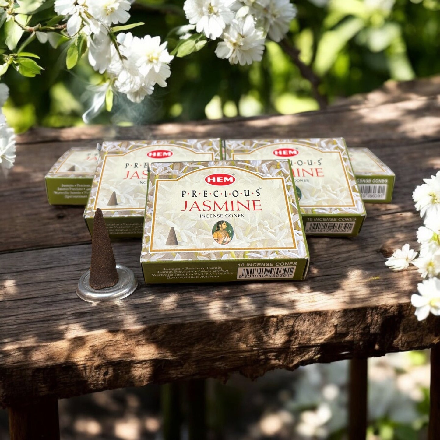 Neatos Elements Precious Jasmine incense cones in packaging on a wooden table with white flowers.