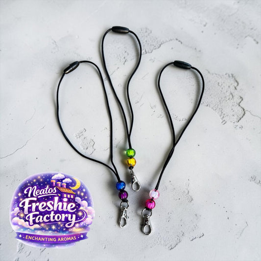 Neatos Elements reusable breakaway clasp hanger with decorative beads and swivel clip. Available in rainbow, blue, and pink.