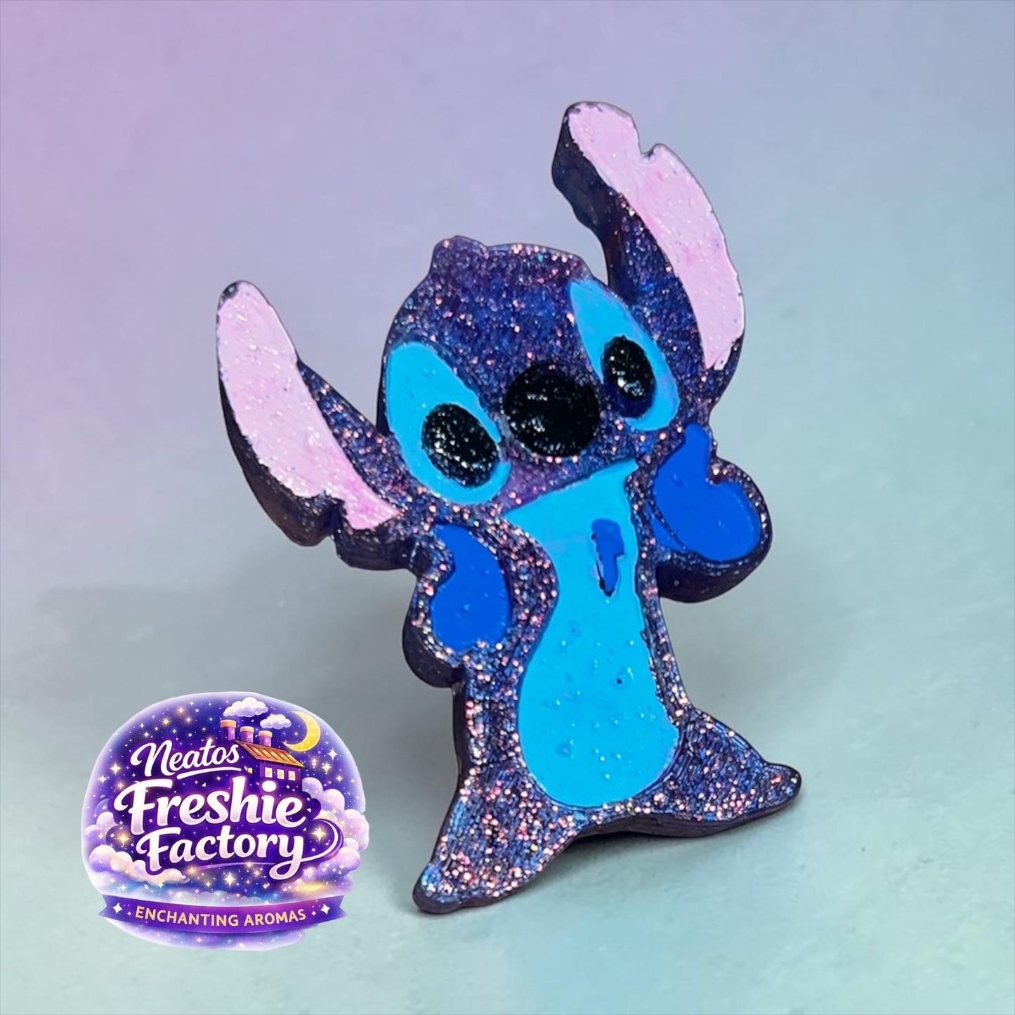 Neatos Elements Cosmic Critter Freshie, a blue and pink glittery aroma bead air freshener shaped like Stitch.