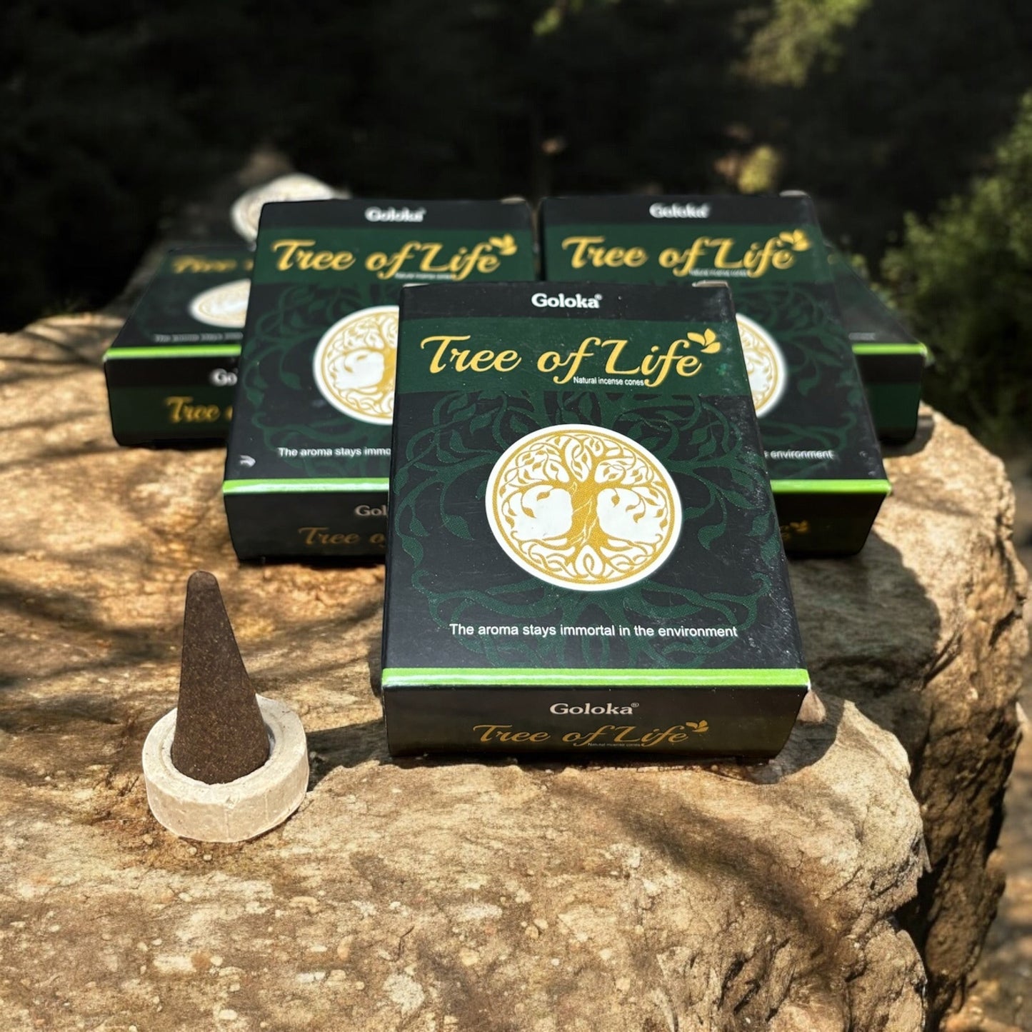 Neatos Elements Goloka Tree of Life incense cones in dark green packaging with a gold tree emblem. One cone rests on a holder.