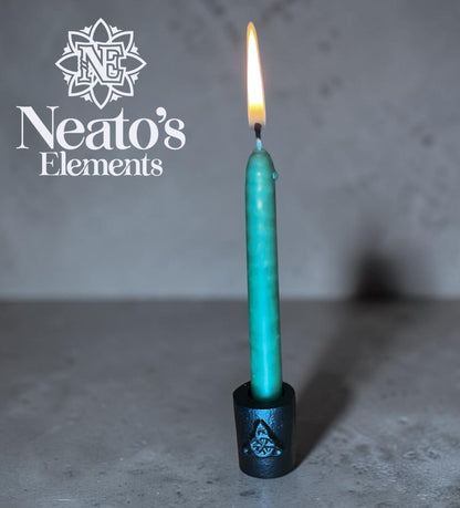 Neato's Elements black cast iron chime candle holder with Triquetra symbol, holding a teal candle.