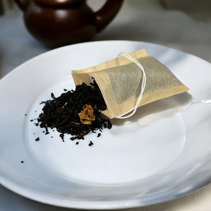 Neatos Elements Tropical Paradise loose leaf black tea blend with mango pieces and blue cornflower petals.