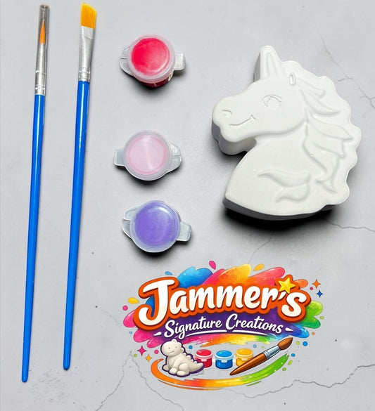 Neatos Elements Enchanted Unicorn paint kit with white plaster unicorn figurine, 3 paint pots (red, pink, purple), and 2 paint brushes.