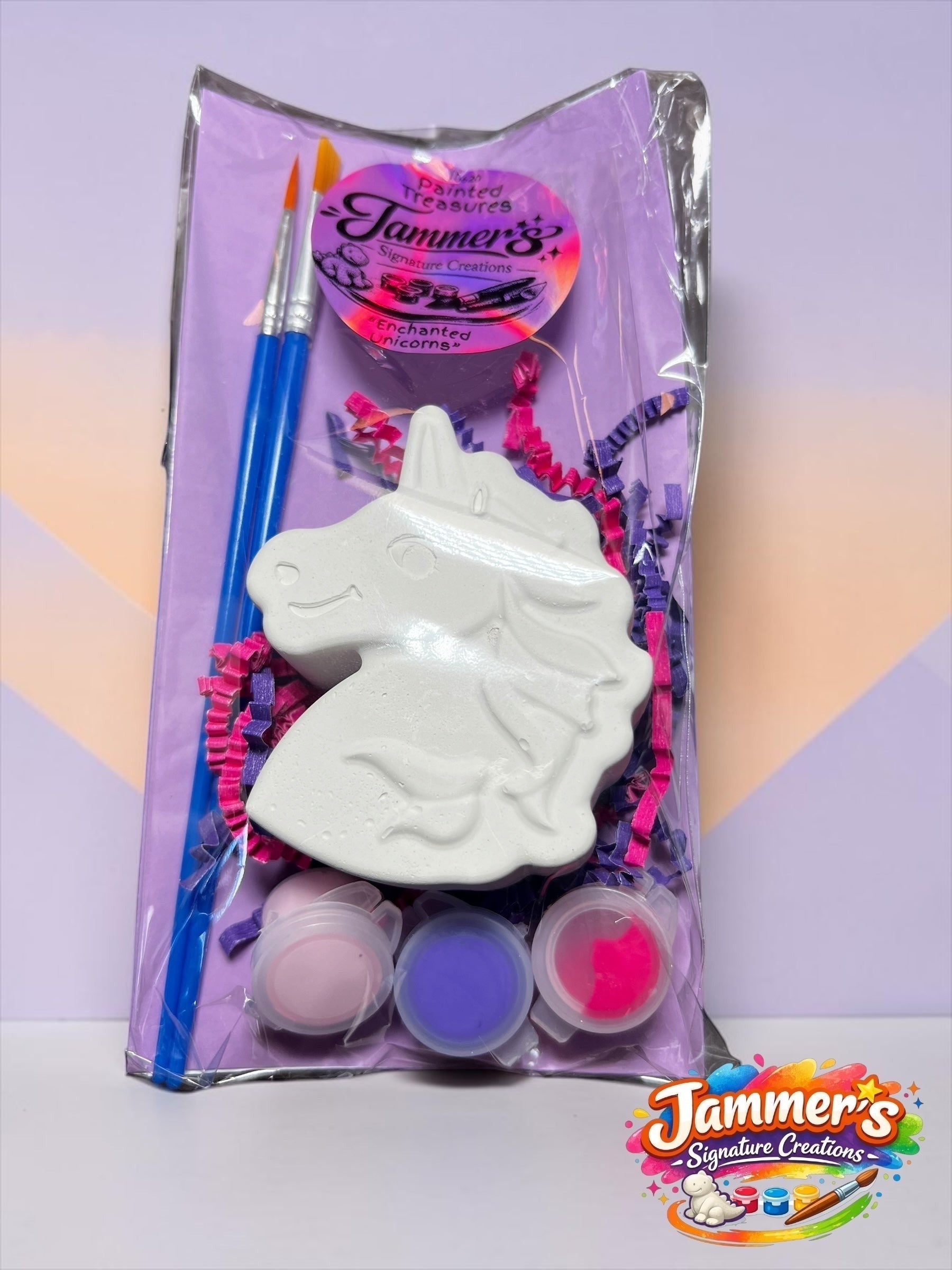 Neatos Elements Enchanted Unicorn painting kit with white plaster unicorn figure, 2 paint brushes, and 3 pots of pink, purple, and hot pink acrylic paint.