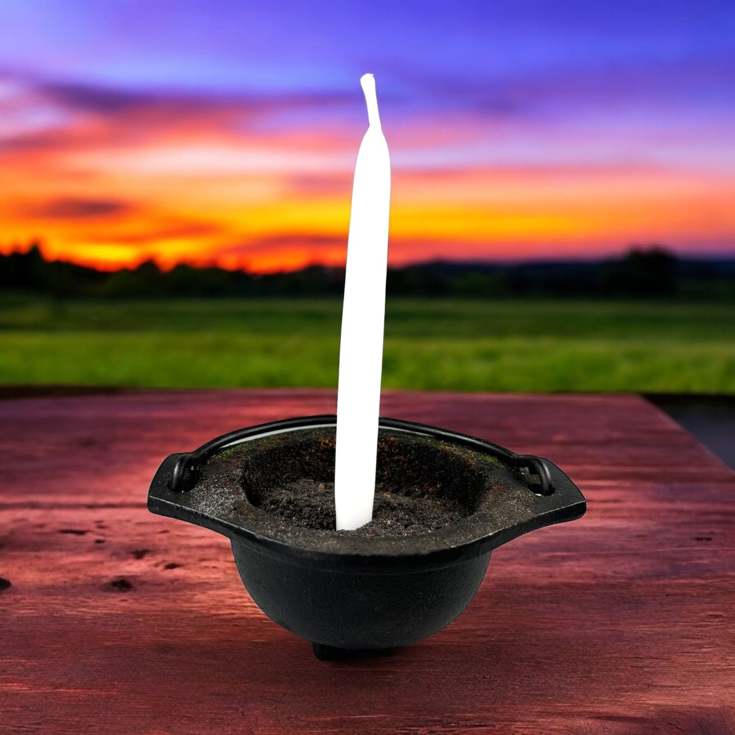 Neatos Elements hand-dipped white candle in a cauldron, ideal for divination and protection rituals.