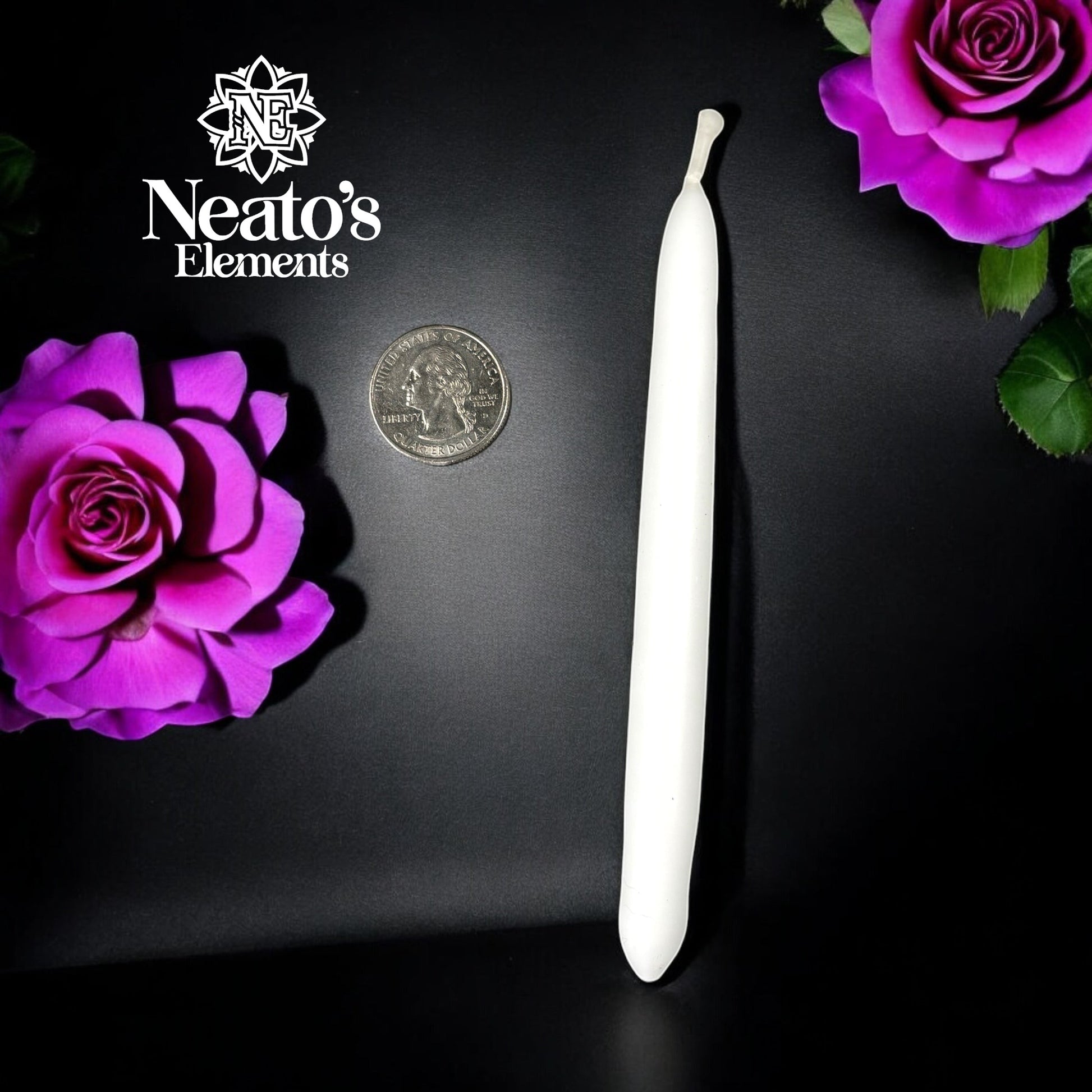 Neatos Elements hand-dipped white taper candle, approximately 5.25 inches long, with a quarter for scale, surrounded by purple roses.