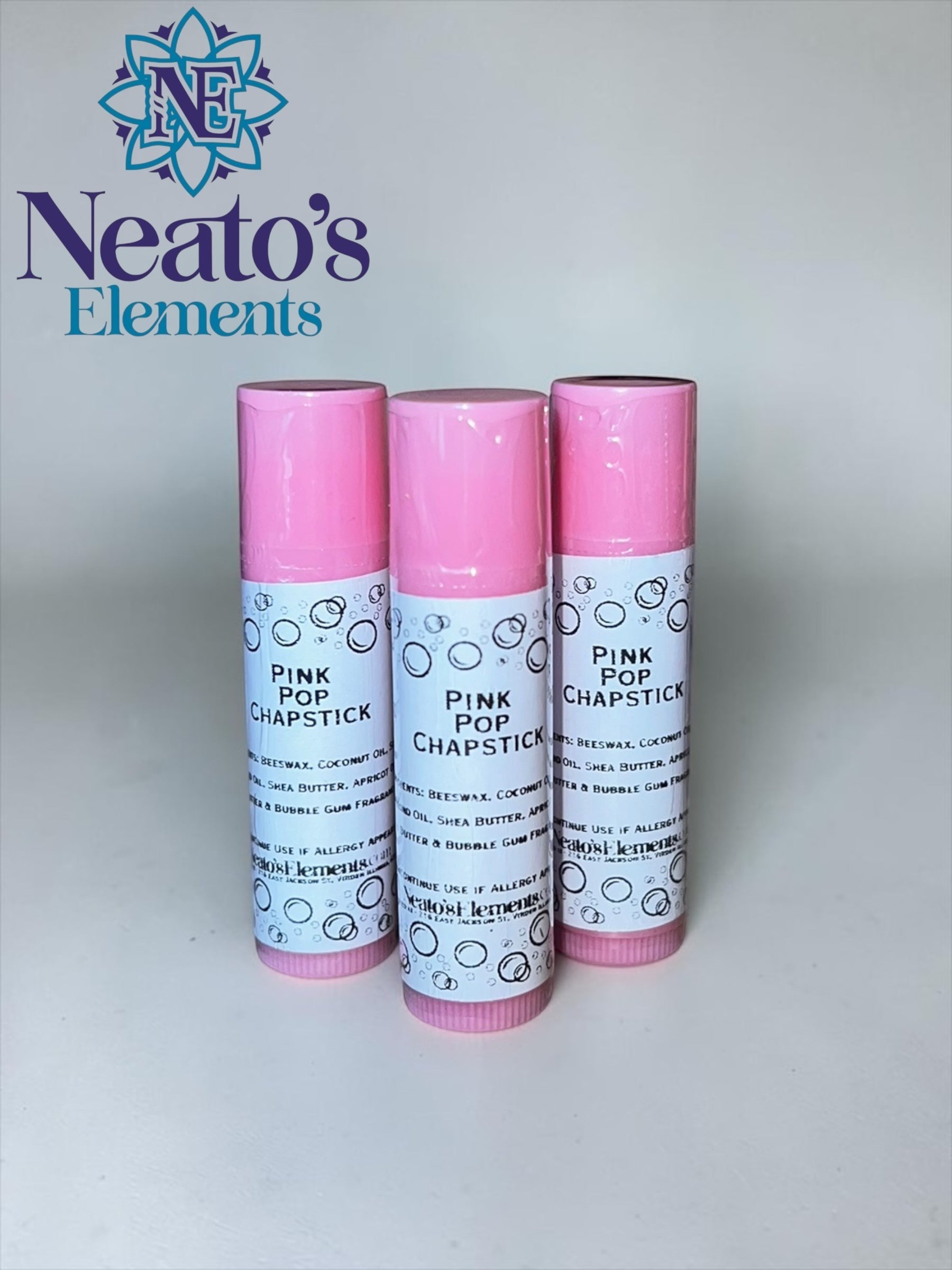 Neato's Elements Pink Pop bubble gum flavored chapstick in a pink tube, made with beeswax and natural oils.